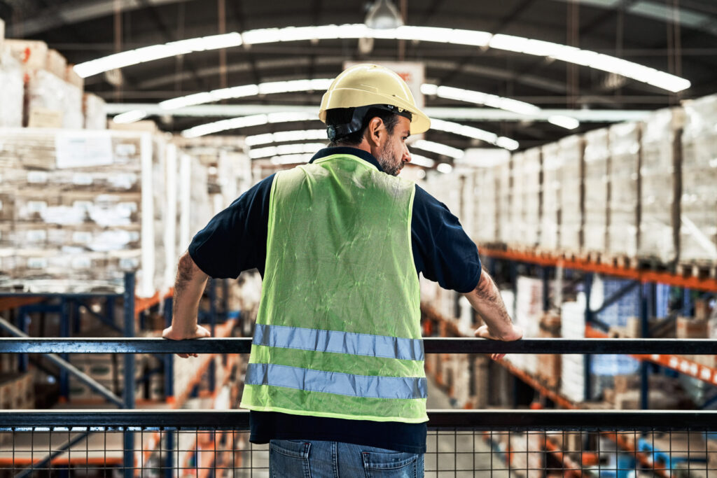 rear view of mature male worker at warehouse