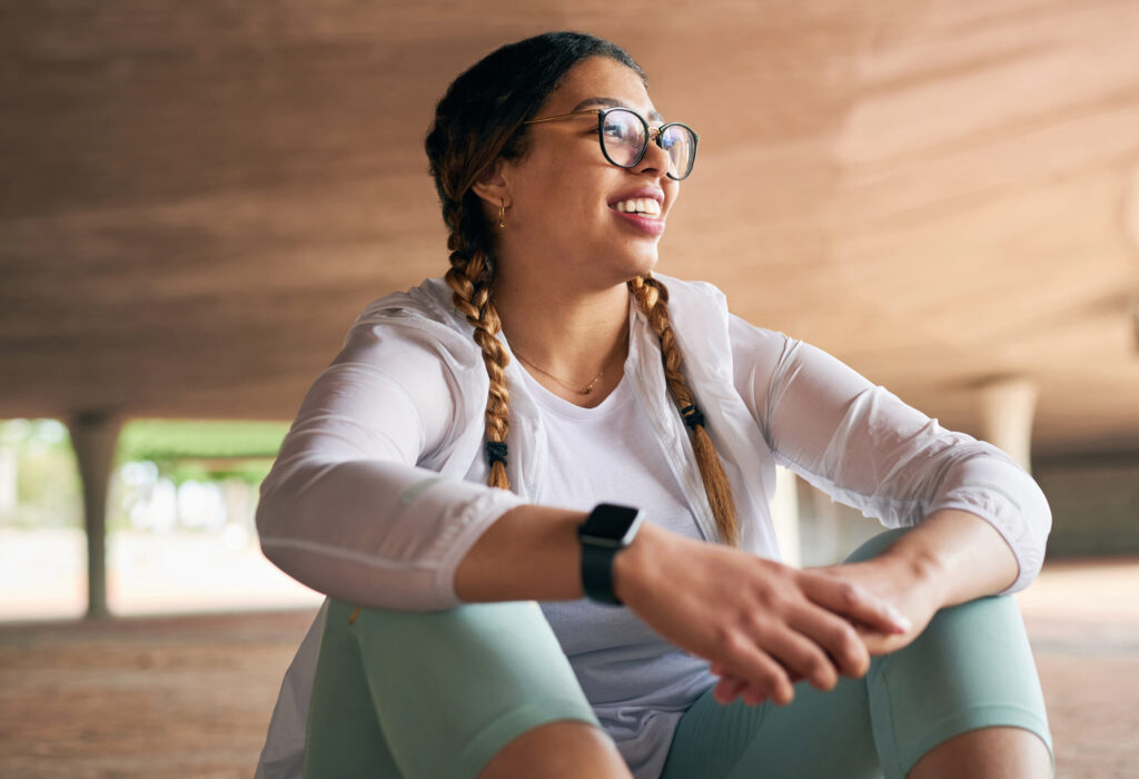 shot of a sporty young woman taking a break while exercising outdoors