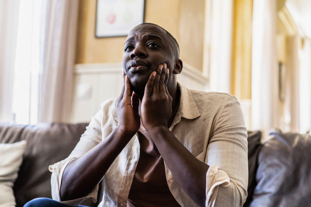 worried man sitting alone in his home
